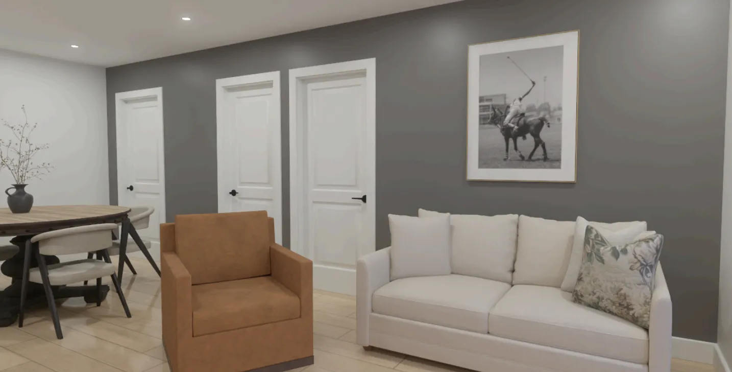 Design rendering of The Canadiana Suite at Inspire Beach Resort: a sitting and dining area with a white sofa, a tan armchair, a round dining table, and a large black-and-white equestrian photograph on a grey wall.