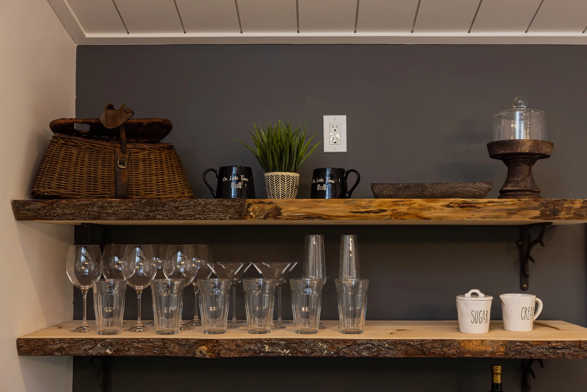 Wooden kitchen shelves with glasses and mugs in The Rustic Lodge.